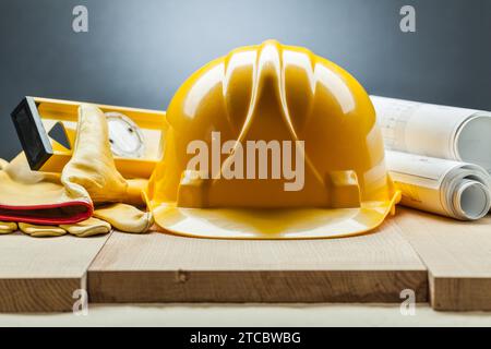 Construction level Helmet Gloves Blueprints Stock Photo