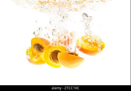 Fresh Nectarine with water splash isolated over white background. Health concept Stock Photo