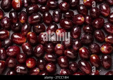 Background from red grapes covered with water drops. Dark vivid theme Stock Photo