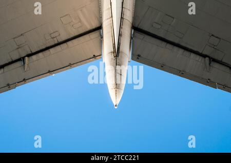 Fragment of airplane wings on a background of blue sky isolated background Stock Photo