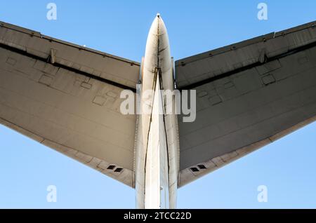 Fragment of airplane wings on a background of blue sky isolated background Stock Photo