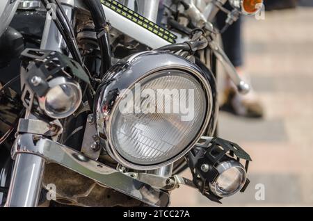 Chrome shiny chopper motorcycle headlight closeup Stock Photo