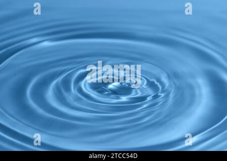 Texture, background with falling water drops and waves with blue water Stock Photo