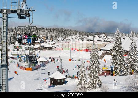 Kopaonik, Serbia, January 22, 2016: Ski resort Kopaonik, Serbia, ski slope, people on the ski lift, mountains, houses and buildings panorama Stock Photo