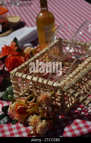 A woven box with wine glasses on a picnic blanket Stock Photo