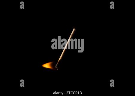 Lit and falling match on a black background. Stock Photo
