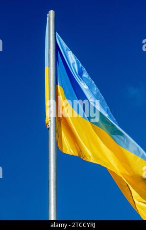 Ukrainian flag with blue sky in the background Stock Photo