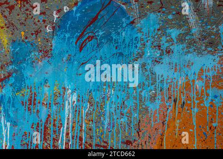 White plastered wall splattered with red paint. Paint splashes on the wall. Painted plaster wall. Abstract background. Painted plaster texture. Stock Photo