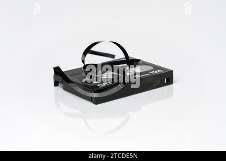 DAT (Digital Audio Tape) cassette with twisted tape isolated on white Stock Photo