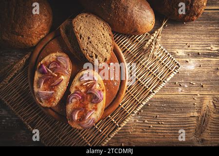 Top view of slices of bread with lard, red pepper powder and onion Stock Photo
