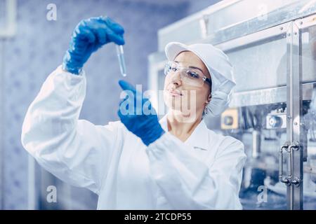 Industry scientist qc staff work checking testing quality of products water in drinking water plant production line. Stock Photo