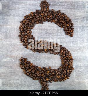 Dollar sign, formed with roasted coffee beans, coffee price Stock Photo