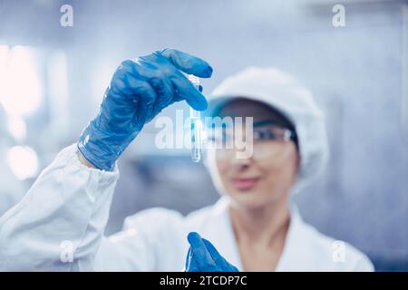 Industry scientist qc staff work checking testing quality of products water in drinking water plant production line. Stock Photo