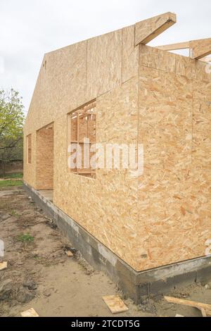 Prefabricated wooden house construction site, wood beam joists and wood chip boards, selective focus Stock Photo