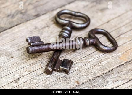 Old iron keys on wooden background. Top secret, confidential or classified concept. Stock Photo