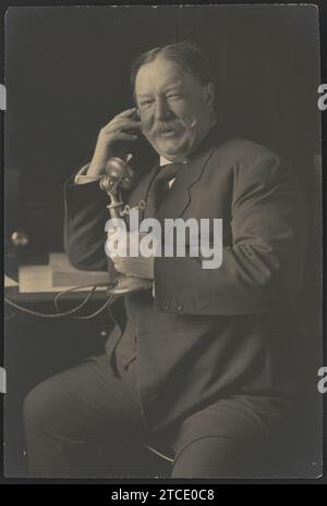 William Howard Taft, three-quarter-length portrait, seated, facing front, smiling while talking on a telephone as he receives news of his nomination as the 1908 Republican presidential Stock Photo