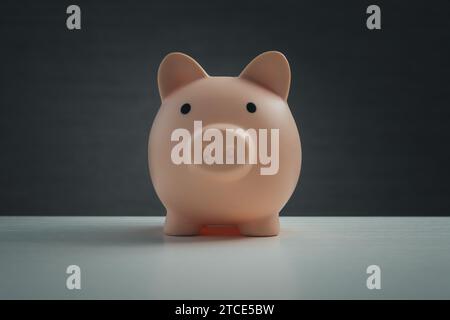 Piggy bank on a dark background. Banking concept. Bright lights on a black background Stock Photo