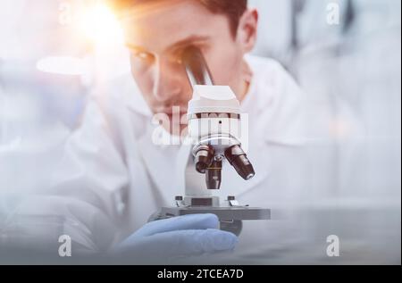 close up. the scientist looks through the microscope Stock Photo