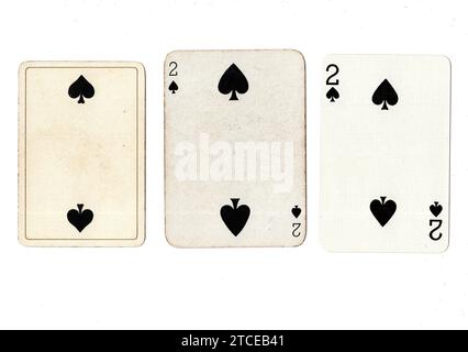 Three two of spades vintage/antique playing cards in various designs isolated on a white background. Stock Photo