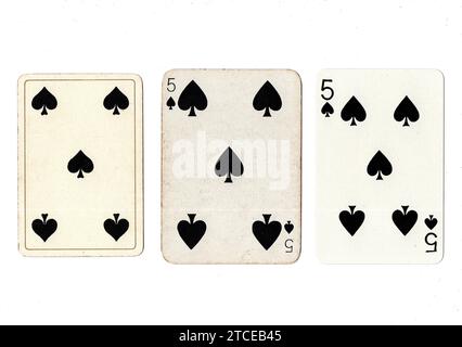 Three five of spades vintage/antique playing cards in various designs isolated on a white background. Stock Photo