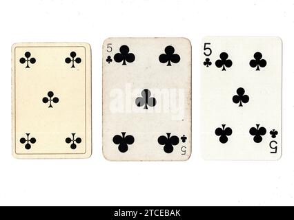 Three five of clubs vintage/antique playing cards in various designs isolated on a white background. Stock Photo
