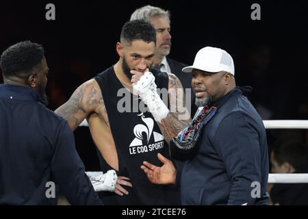 Paris, France. 10th Dec, 2023. Tony Yoka of France and his coach Don Charles are dejected following his defeat in the Heavyweight boxing event against Ryad Merhy of Belgium on December 9, 2023 at Stade Roland-Garros in Paris, France - Photo Jean Catuffe/DPPI Credit: DPPI Media/Alamy Live News Stock Photo