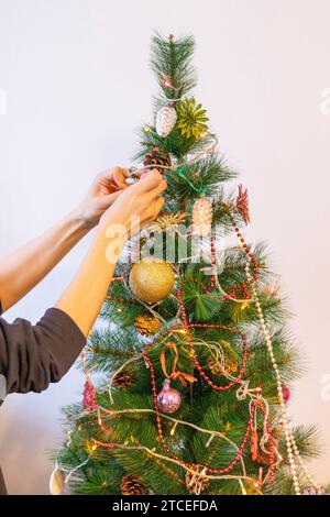 Close up shot of woman decorating christmas tree. Stock Photo
