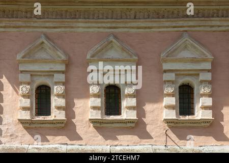 Three windows of a medieval church arranged in a row. Stock Photo