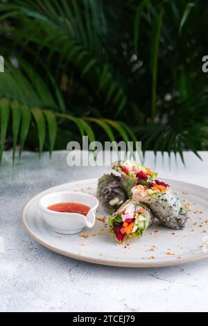 Spring rolls with vegetables and shrimp on white plate Stock Photo