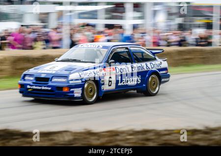 1989 Ford Sierra Cosworth RS500 saloon car racing up the hillclimb track at the Goodwood Festival of Speed 2016. BTCC Labatt's sponsorship Stock Photo