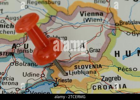 A red pin stuck into a map of Western Europe, pinpointing the location of Ljublijana Stock Photo