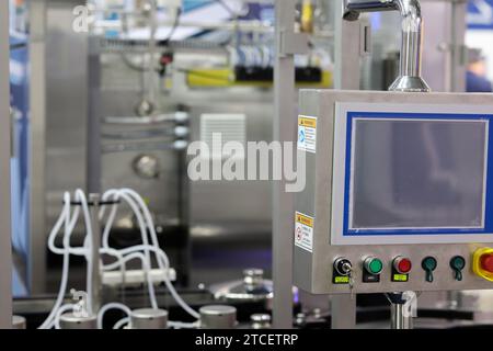 Stainless steel control console of automated industrial equipment. Touchscreen control panel. Selective focus. Stock Photo