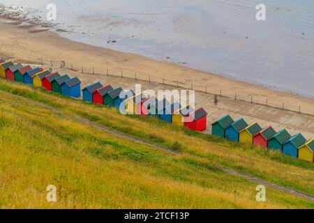 Seaside rainbow coloured huts on the coast of Whitby, UK. Stock Photo