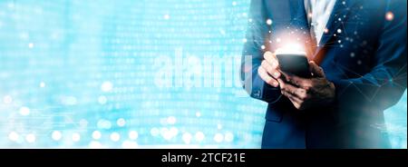 Futuristic banner. Man using mobile phone and laptop computer with digital technology. Internet of Things IoT, digital marketing, e-commerce, global b Stock Photo