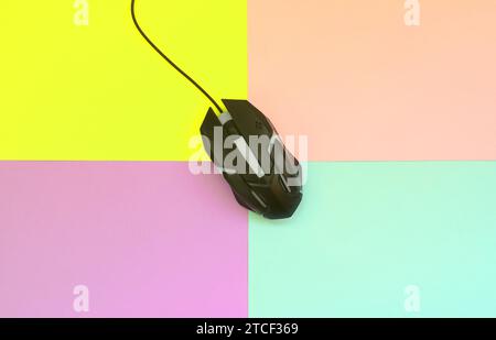 Optical gaming mouse is located between areas of different colors. Device for cybersport and online video games. Flat lay minimal. Top view Stock Photo
