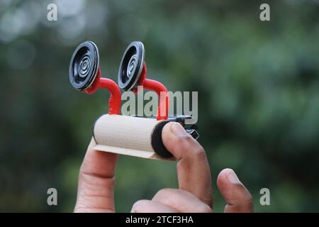 Portable bluetooth speaker held in the hand on a nature background. Unique type of music player that is wireless Stock Photo