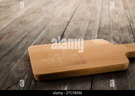 Wooden rectangular cutting board on rustic table. Stock Photo