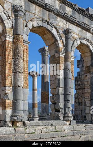 Arched outer wall of basilica faced with columns at Volubilis, Berber-Roman city from ancient Mauretania near Meknes, Fez-Meknes, Morocco Stock Photo