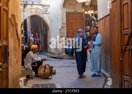 Moroccans wearing traditional kaftans in alley of medina in the city Fes / Fez, Fez-Meknes, Morocco Stock Photo