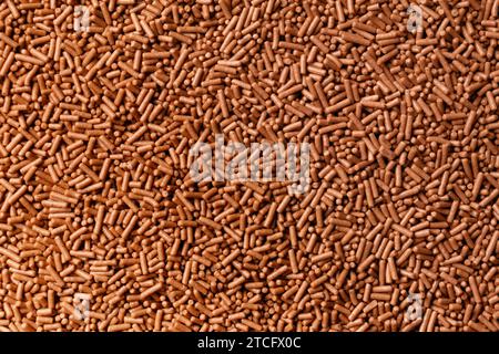 Chocolate chip background close-up, milk chocolate chip as abstract texture background with space for text. Stock Photo