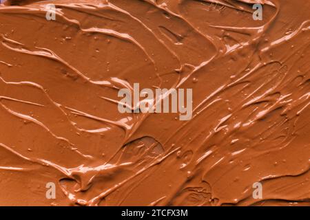 Chocolate background. Melted chocolate. Liquid milk chocolate. Handmade chocolate. Stock Photo