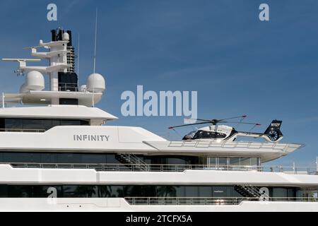 Miami, Florida, USA - 5 December 2023: Luxury super yacht Infinity with a helicopter on its deck. The ship is owned by Eric Smidt. Stock Photo