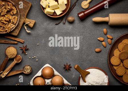various baking ingredients on dark grey background Stock Photo