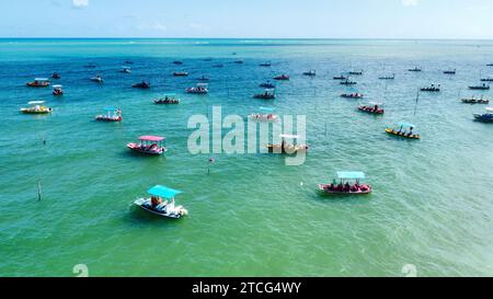 Colorful boats floating on the water in San Miguel de Milagres in Brazil. Stock Photo