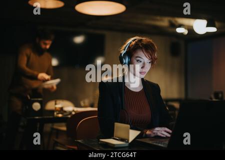 Businesswoman discussing data analytics for successful global expansion in a creative office Stock Photo