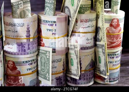 Piles and bundles of Egypt money  thousands of Pounds currency banknotes bills rolls of 200 EGP LE, Egyptian money exchange rate and USA American doll Stock Photo