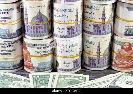 Piles and bundles of Egypt money  thousands of Pounds currency banknotes bills rolls of 200 EGP LE, Egyptian money exchange rate and USA American doll Stock Photo