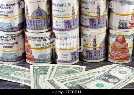 Piles and bundles of Egypt money  thousands of Pounds currency banknotes bills rolls of 200 EGP LE, Egyptian money exchange rate and USA American doll Stock Photo