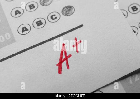 School grade. Red letter A with plus symbol on answer sheet, closeup Stock Photo