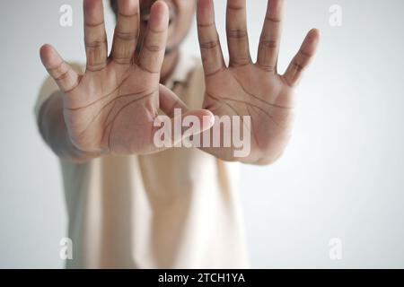 young man show stop sigh isolated in black  Stock Photo